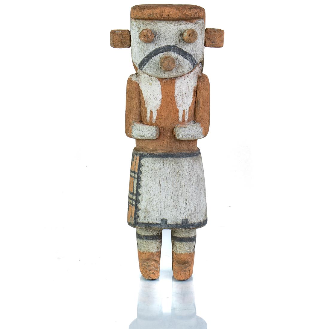 A Hopi Orange Kachina: A Hopi Orange Kachina with a typical stance of arms held against its sides, wearing a kiva step kilt with an orange background, 9.5"h