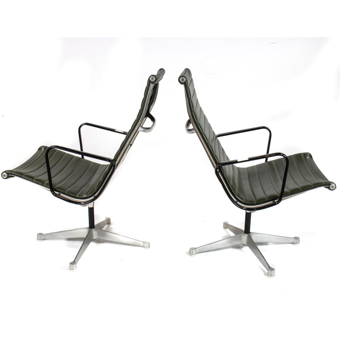 A pair of Charles and Ray Eames for Herman Miller Aluminum group chairs: A pair of Charles and Ray Eames for Herman Miller Aluminum group chairs, each with green upholstery, above aluminum legs, 34.5"h x23" x 23"d.