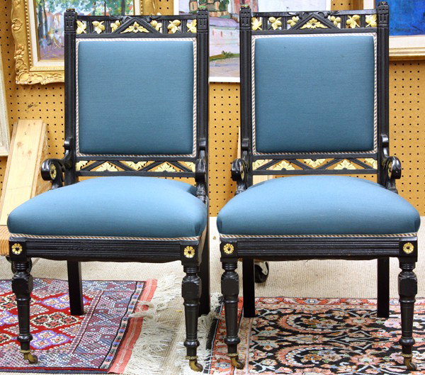 Eastlake ebonized chair group: (lot of 2)Pair of American Aesthetic Movement ebonized chairs, having a pierced and gilt decorated crestrail flanked with incised stiles terminating at the relief carved supports with gilt rosette med