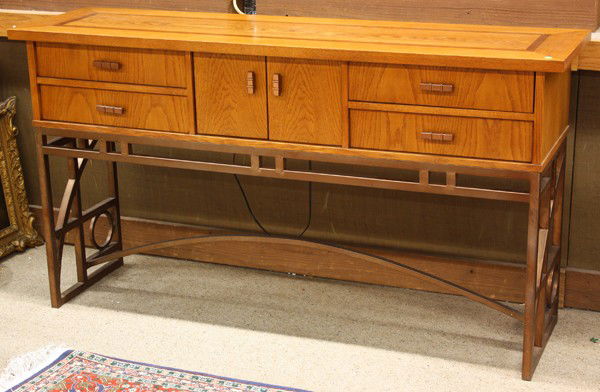 Prarie style sideboard: Prairie style sideboard, the oak case with a band inlaid top above a patinated metal base having geometric decorated sides in the style of Frank Lloyd Wright and conjoined with an arched stretcher, 36