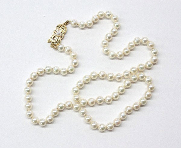 Mikimoto pearl choker necklace: MIKIMOTO cultured pearl choker necklace; having an 18k yellow gold clasp with pearl accent. Necklace is set with pearls ranging from 5 - 5.5 mm. Necklace length 18''