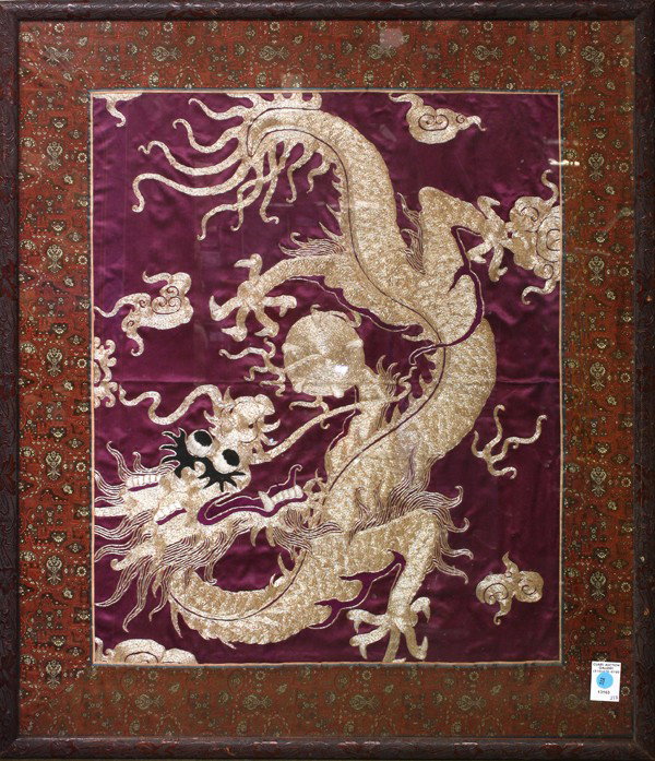 Chinese Dragon Embroidered Silk Panel: Framed Chinese silk panel, embroidered and couched with a meandering dragon in pursuit of a sacred jewel couched with metallic threads and accented with satin stitches executed in colored silk threads