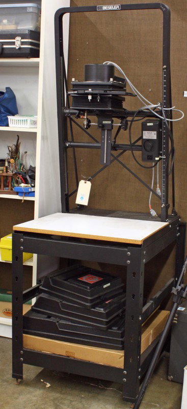 Beseler 45 MXT enlarger: (lot of 6) Beseler 45 MXT enlarger and accessories, enlarger includes cold light head, and a lens turret with two mounted lenses (Nikkor 50mm f2.8 and Nikkor 75mm) on a Beseler stand, under the chassi