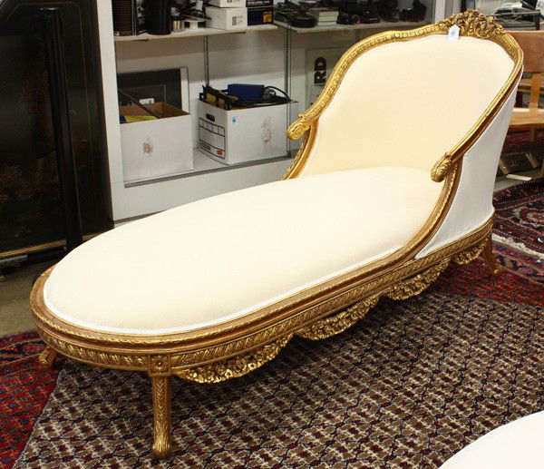 Gilt carved chaise lounge: Gilt carved chaise lounge, the scrolling and carved crestrail continuing to the sloping arms terminating at the acanthus carved returns and rising on stylized cabriole legs, 39.5''h x 29.5''w x 77''l