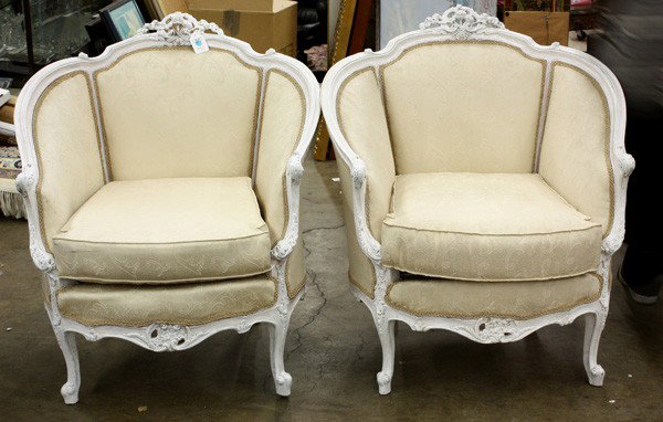 Pair bergeres: Pair of paint decorated bergeres, each having a pierce carved floral crest above the rounded crestrail terminating at the acanthus carved returns and rising on cabriole legs, 37''h x 33.5''w x 28''d