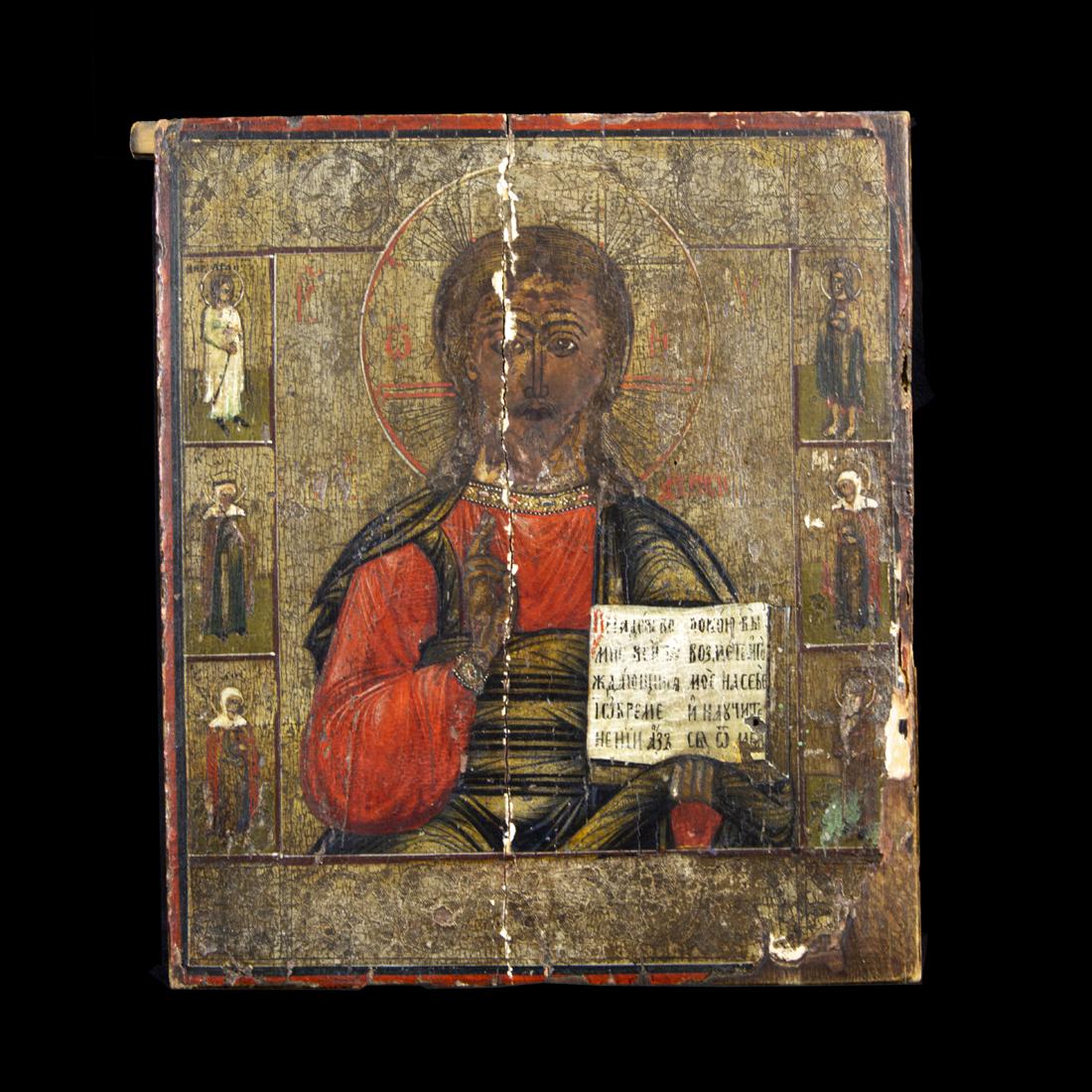 A Russian Icon of the Word of God: A Russian Icon of the Word of God, the rectangular form with half figure of Jesus in red robe, holding a book in one hand, his other hand raised in benediction, each side of the border with three sain