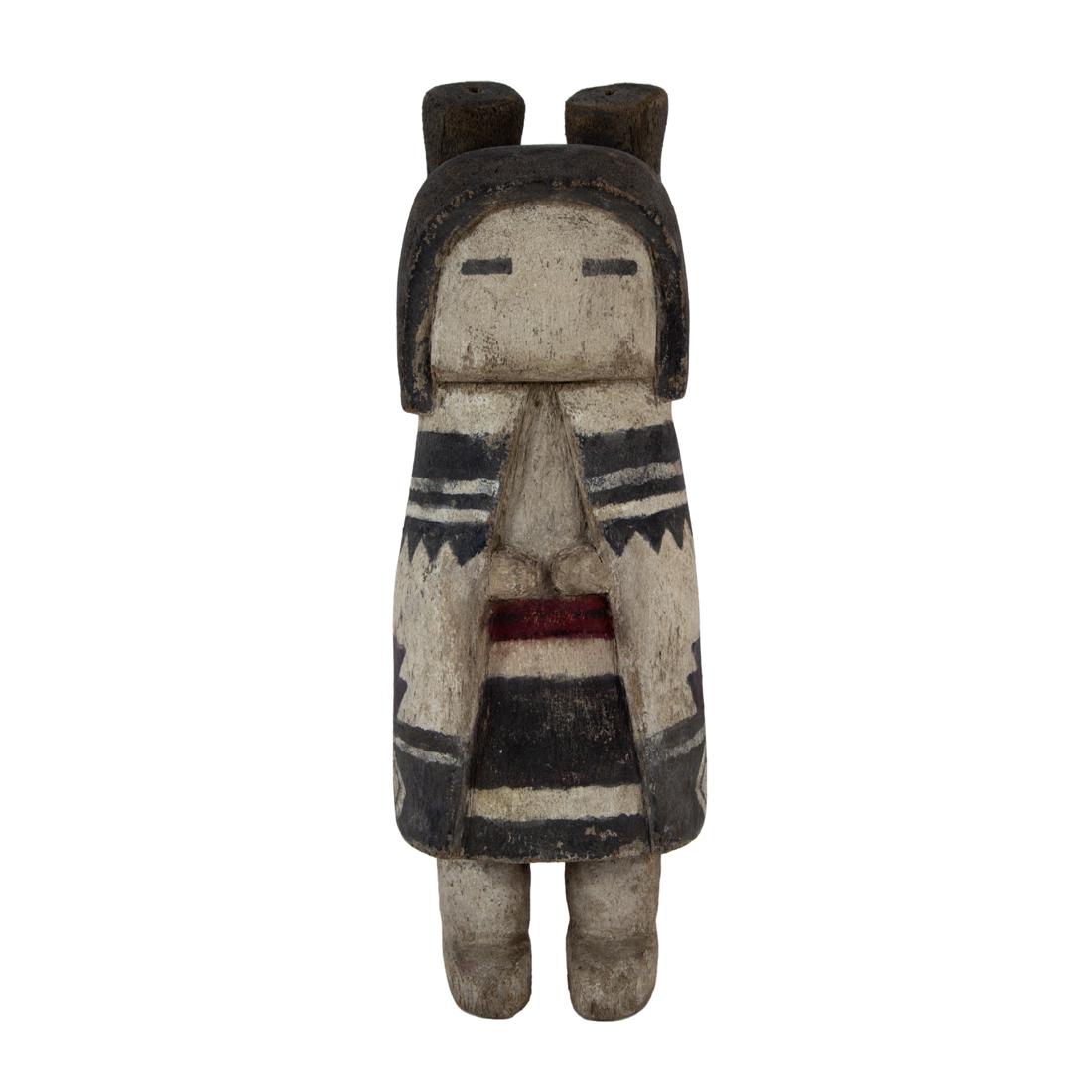A Hopi kachina doll: A Hopi kachina doll, the adolescent female featuring the classic matrimonial hair buns and a highly detailed embroidered kilt. 9.75" h x 3.5"w x 3"d
