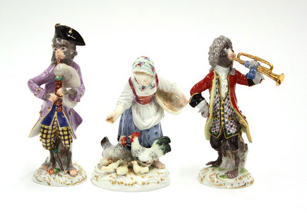 Meissen group: (lot of 3) Meissen figural groups, each polychrome decorated and marked with underglaze cross sword marks, one depicting a youg girl feeding game and rising on a Rococo style plinth, incised 2874, two