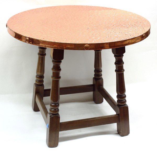Arts and Crafts copper top table: Arts and Crafts copper top table, the circular hammered top above a baluster turned base in the Monterey style conjoined by a box stretcher, 19''h x 23.5''w