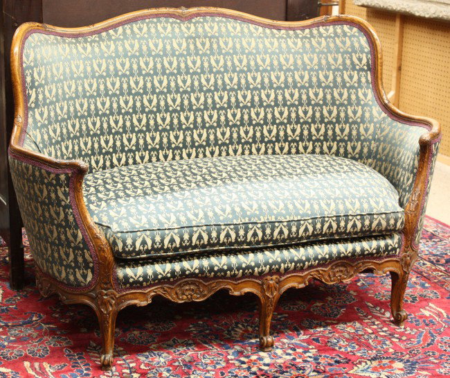 Victorian Rococo style settee: Victorian Rococo style settee, having a carved crestrail continuing to the arms accented with a rosette medallion above the bellflower carved return and rising on cabriole legs, 38''h x 55''w, circa 1
