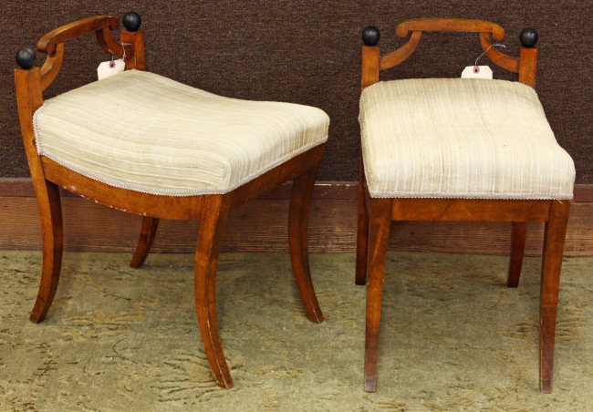 Biedermeier style benches: Pair of Biedermeier style vanity benches circa 1890, each having a scroll crest with upswept supports terminating at the square stiles surmounted with ebonized spherical finials and rising on outswept