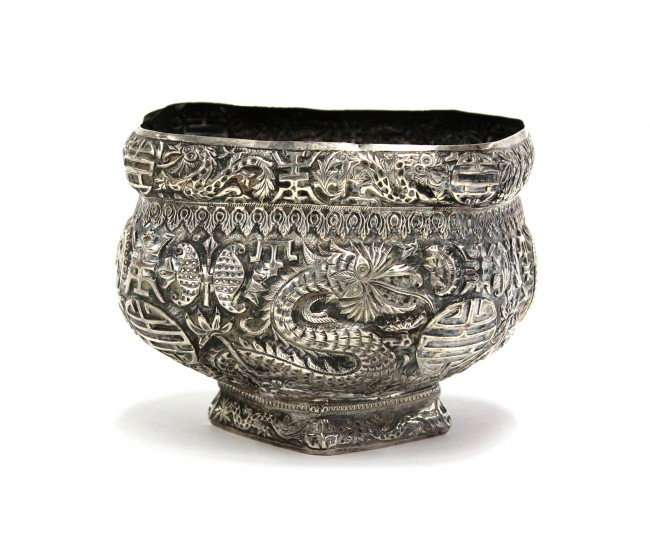 Chinese-Inspired Silver Dragon Bowl: Chinese-inspired silver repousse decorated bowl, possibly of Southeast Asian origin, the square body with rounded corners centered by large shou medallions accompanied by fanciful dragons and stylized