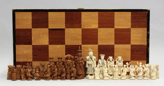 Chinese Ivory Chess Set: Chinese ivory chess set, 20th century, featuring two groups each led by their respective their Han and Manchu emperor and empress bracketed by the bishops, rooks, knights, and pawns fashioned as the E