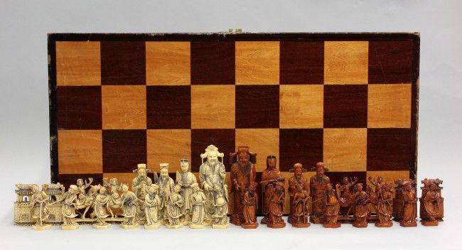 Chinese Ivory Chess Set: Chinese ivory chess set, 20th century, one group of natural coloration and the other tinted a brown hue, each featuring the emperor and empress, accompanied by guards, horseman, and towers, along with