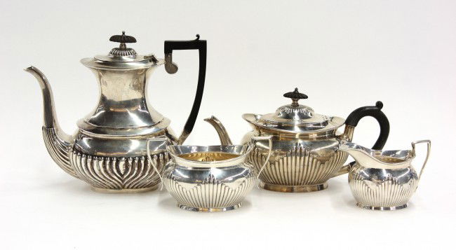 English sterling service: English sterling silver four piece service, Birmingham, 1881, by Frederick Elkington, comprising a coffee pot, tea pot, open sugar basin, and creamer, decorated with embossed fluting, both pots with e