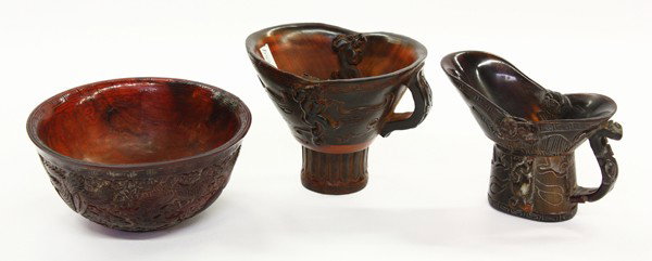 Chinese Carved Horn Decorative Items: (Lot of 3) Chinese carved horn decorations, consisting of: two libation cups, one with a spouted mouth accented by bats and chilong in relief, the tall pedestal foot incised with a taotie mask and mea