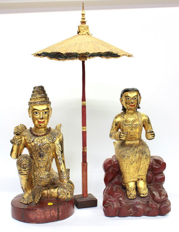 Southeast Asian Gilt Figures: (Lot of 3) Southeast Asian gilt figures and umbrella, the first of male attendant seated with one arm extended (lacking umbrella), the second depicting a seated female attendant with legs pendent and