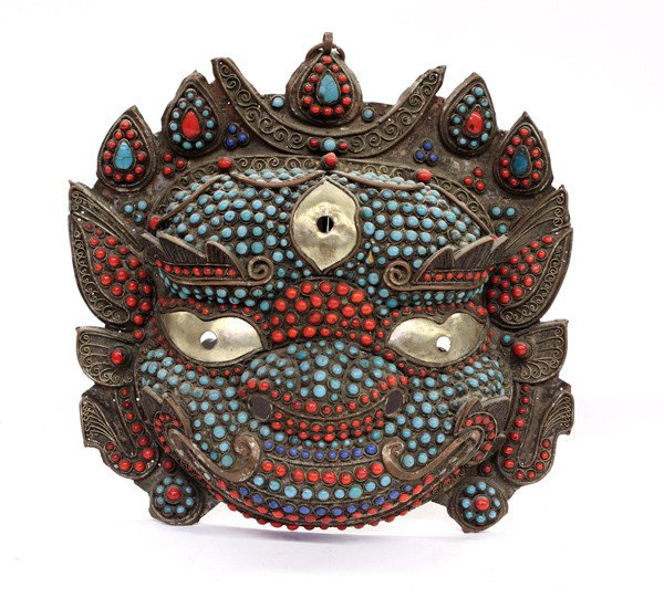 Nepalese Inlaid Mask: Nepalese copper and silver mask with colored glass inlay, the leonine head with three silver eyes and a five-point diadem with a crescent moon, the features picked out in turquoise, blue and coral-col