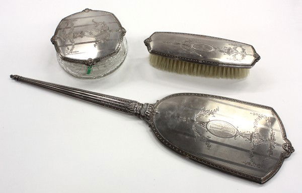 Sterling dresser set: American sterling silver mounted three piece dresser set, by International, having a hand mirror, crystal bowl, and a brush, showing a Neo-Classical appearance
