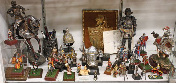Medieval lead Knights & Soldiers: (1 large shelf) Medieval model knights and associated items, including a pair of French heraldic wall hangings, a brass knight on his steed wall hanging, large models of knights in armour, three on ho