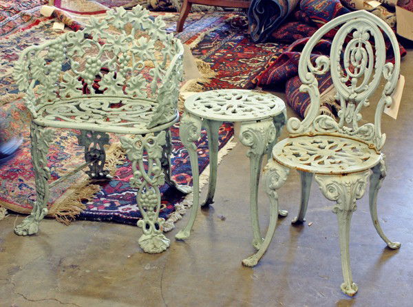 Victorian cast iron furniture: (Lot of 3) Victorian cast iron parlor set, the paint decorated childs set including a settee, side chair, and occasional table