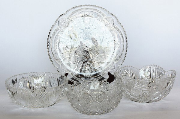 Cut glass table articles: (Lot of 4) American brilliant cut glass table articles, three bowls and one tray having sawtooth rims and various decorations including hobstars, pinwheels, and diamonds