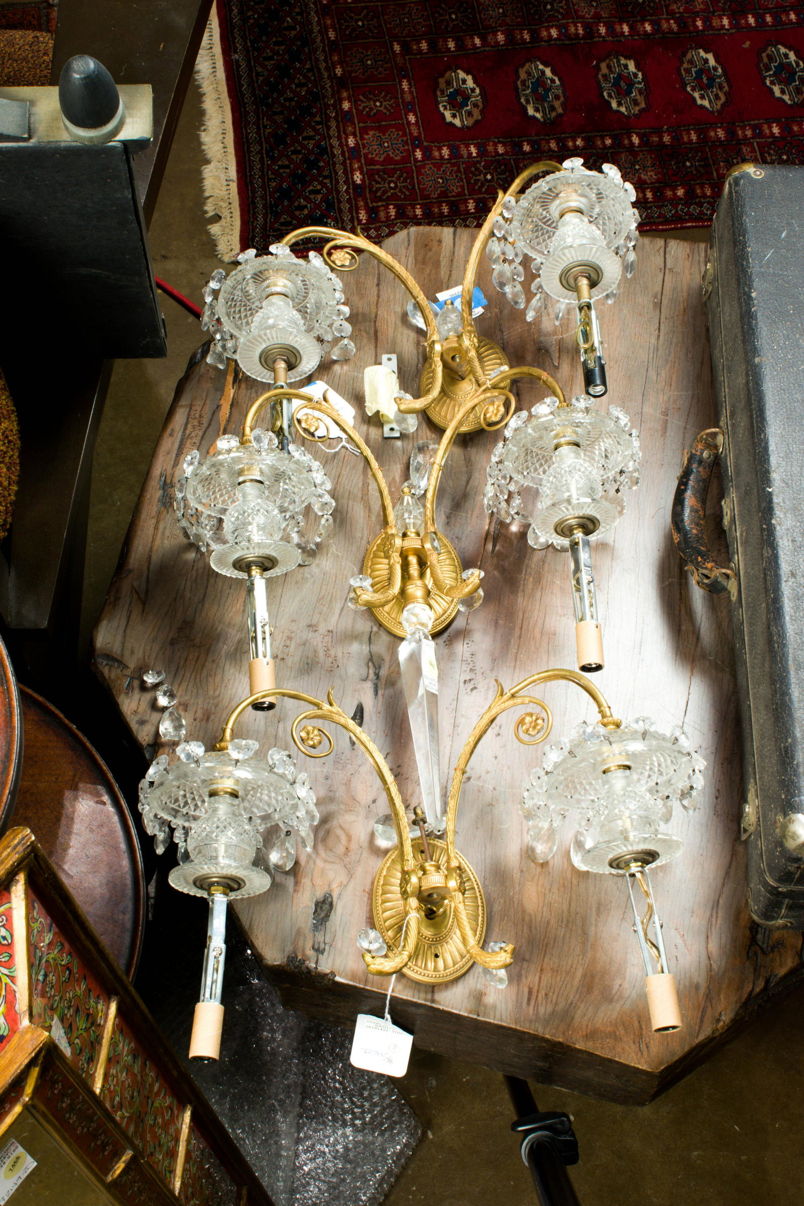 (lot of 3) Louis XVI style gilt bronze and cut glass two-light wall lights: (lot of 3) Louis XVI style gilt bronze and cut glass two-light wall lights, each sconce with oval patera backplate issuing two eagle headed candlearms, greatest 13"h x 15"w x 7.5"d.