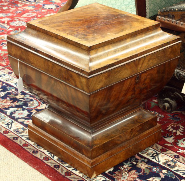 William IV cellarette: William IV mahogany cellarette, having a band inlaid square top opening to reveal a fitted interior, above the tapering case with flame mahogany panelsand rising on a graduated plinth, 23''h x 21''d