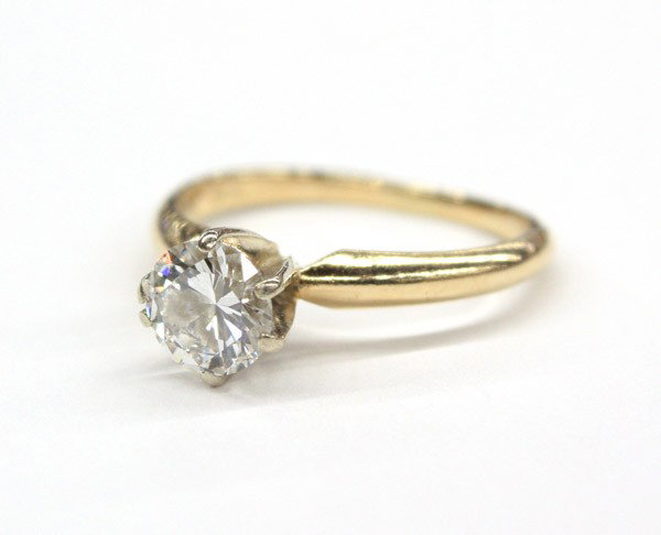 Diamond solitaire engagement ring: Diamond solitaire engagement ring; of 14k yellow and white gold, featuring (1) round brilliant cut diamond weighing 0.77 ct (GIA stating: F color, VS2 clarity). Total ring weight 2.3 grams. Ring size 