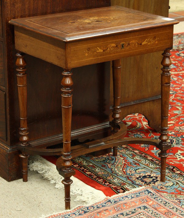 Victorian inlaid sewing table: Victorian inlaid sewing table circa 1875, executed in walnut, having a hinged top with a floral medallion opening to reveal a mirrored and fitted interior and rising on turned and tapered legs, 27''h 