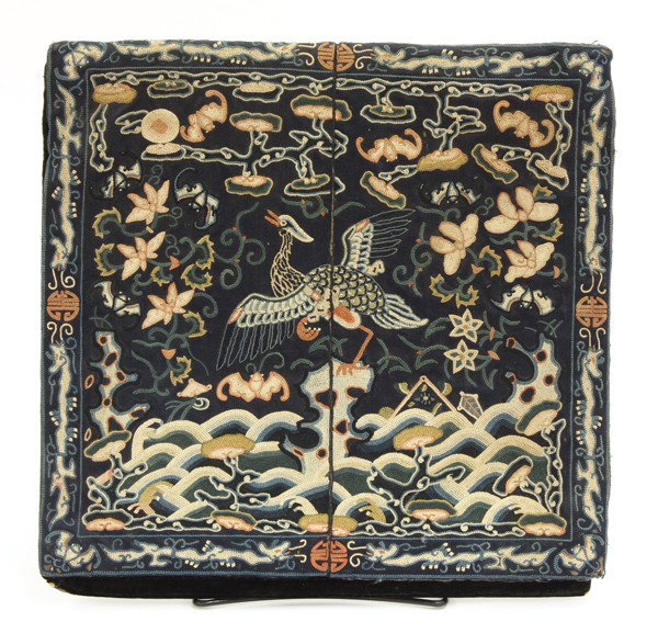Chinese Rank Badge/Mandarin Square: Chinese Mandarin square (rank badge), featuring a blue and white knotted bird perched on a rock above cresting waves and framed by lotus sprigs, bats, ruyi clouds and other auspicious emblems set agai