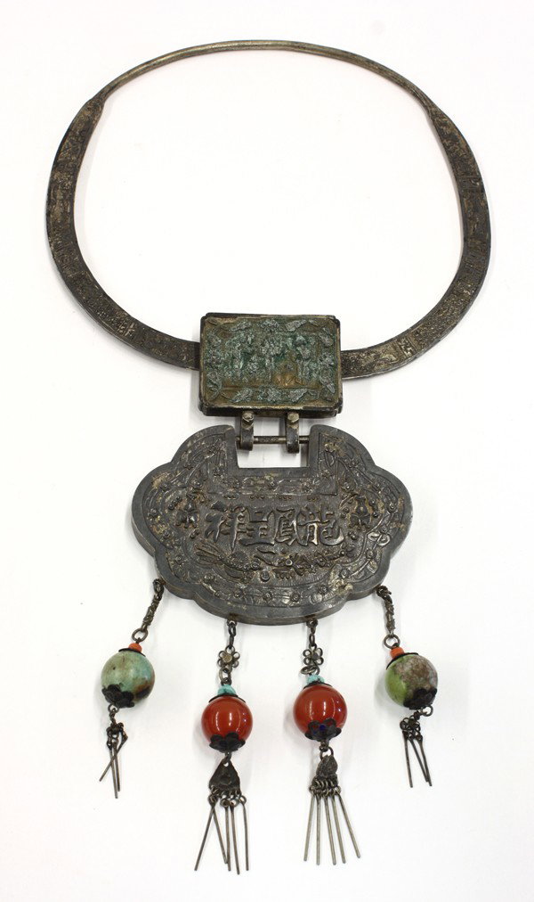 Chinese Silver Torque (Necklace) with Amulets: Chinese silver torque with repousses amulets, the choker decorated with alternating reserves of flowers, figures and geometric bands and centered by a rectangular repousse plaque featuring three elega