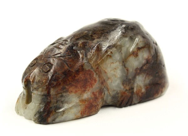 Chinese Jade Carving of a Tiger: Chinese cat-form jade handling piece, possibly Ming/Qing dynasty, incised with large eyes below incised bushy brows and with its ears bracketing the character 'wang' to its forehead, the black and rus