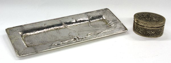 Two Asian Silver Table Decorations: (lot of 2) Asian silver table decorations, the first a rectangular Japanese tray, Meiji/Taisho period, of double wall construction and decorated with flowering iris in repousse on a textured ground, 8