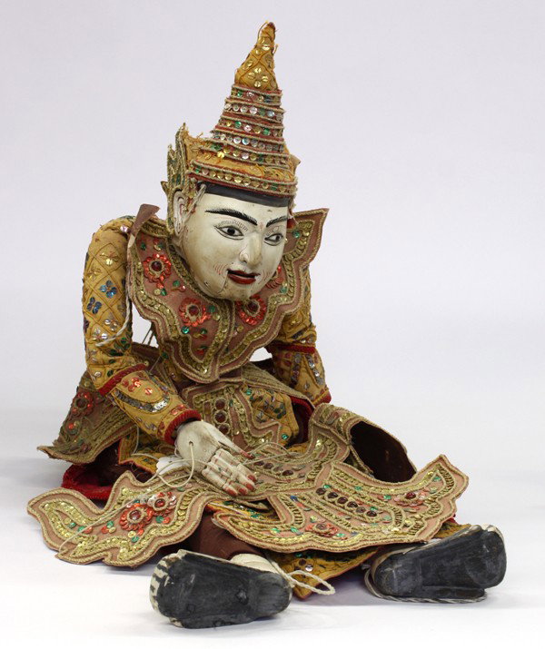 Thai Wooden Puppet: Thai figural wooden puppet, the princely hero with a pigment decorated wooden face brightened with large eyes and fitted with hinged jaws, further decorated with a tiered hat, the wooden limbs adorned