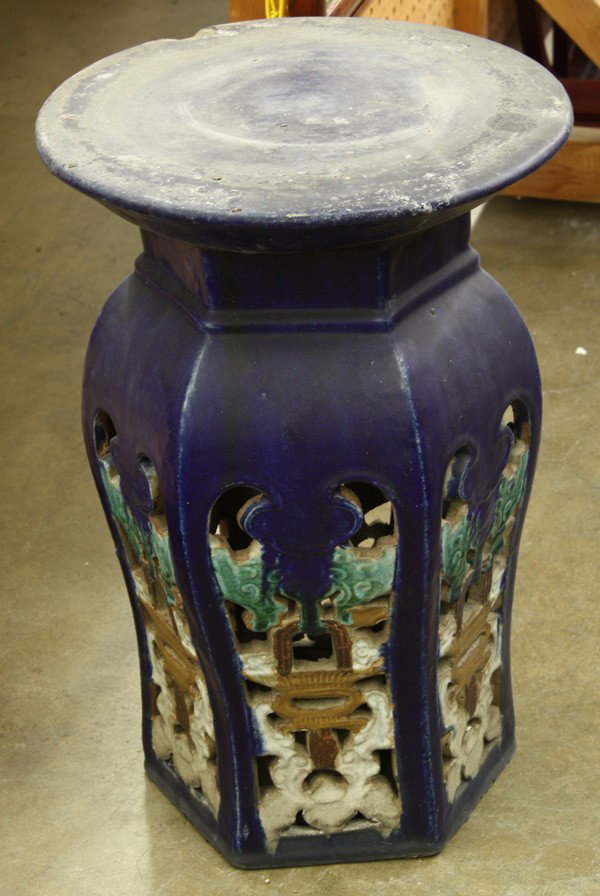 Chinese Glazed Garden Seat: Chinese blue ceramic garden seat, with a circular seat above a hexagonal waist set over the swelling shoulders, the openwork sides each featuring a bat suspending a flower basket heightened in green, 
