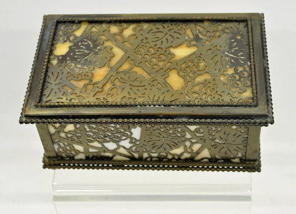Tiffany Studios box: Tiffany & Studios New York 816 bronze box having caramel slag glass panels revealing through the grapevine motif, crack in top panel, restored hinges