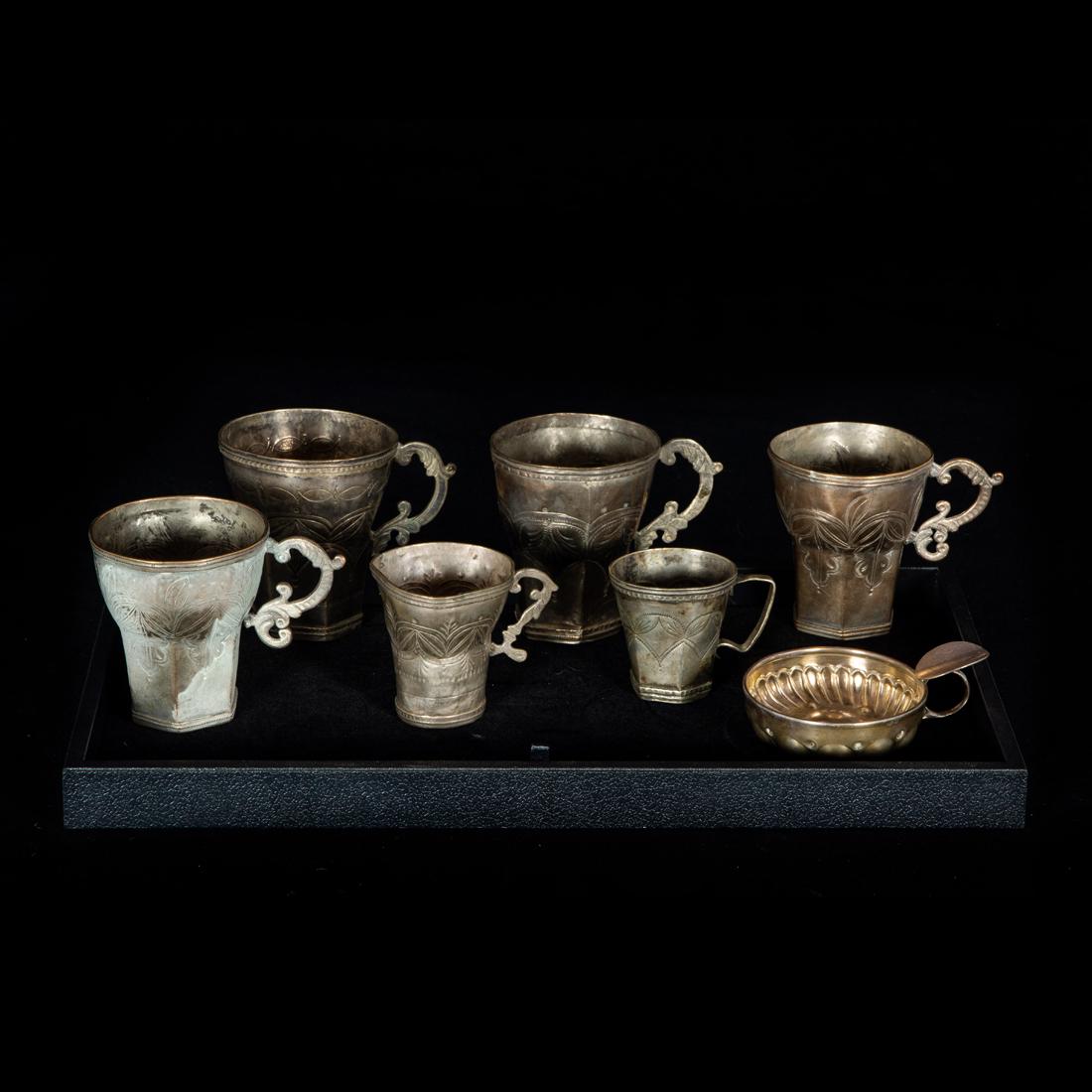 (Lot of 6) Spanish Colonial silvered metal cups with engraved geometric design: (Lot of 6) Spanish Colonial silvered metal cups with engraved geometric design, the larger 3.5"h; en suite with wine taster 3"d