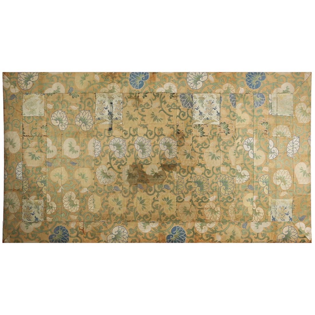 Japanese woven kesa: Japanese woven kesa, assembled from sections of silk brocade with metallic thread decorated with dragons and leaves, mounted on a wood stretcher, 42.5"h. x 78"w. Provenance: Property from the estate o