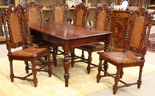 Victorian style dining suite: (lot of 7) Victorian style mahogany dining suite, the harvest table having a rectangular top above the molded apron and rising on ring turned legs, 29.5''h x 71''w x 37''d, together with one armchair 