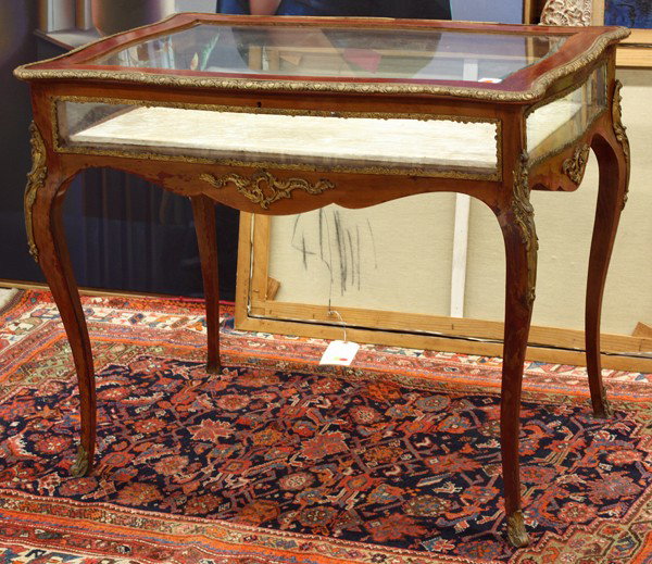 Louis XVI style table vitrine: Louis XVI style table vitrine, circa 1890, having a turtle shape hinged top with gilt mounts opening to reveal the lined base and rising on gilt mounted cabriole legs terminating on sabots, with repla