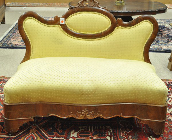 Victorian settee: Transitional Victorian child's settee circa 1850, executed in mahogany and having a shaped back with an over stuffed serpentine seat rising on a conforming base terminating on shaped feet, 33''h x 41'