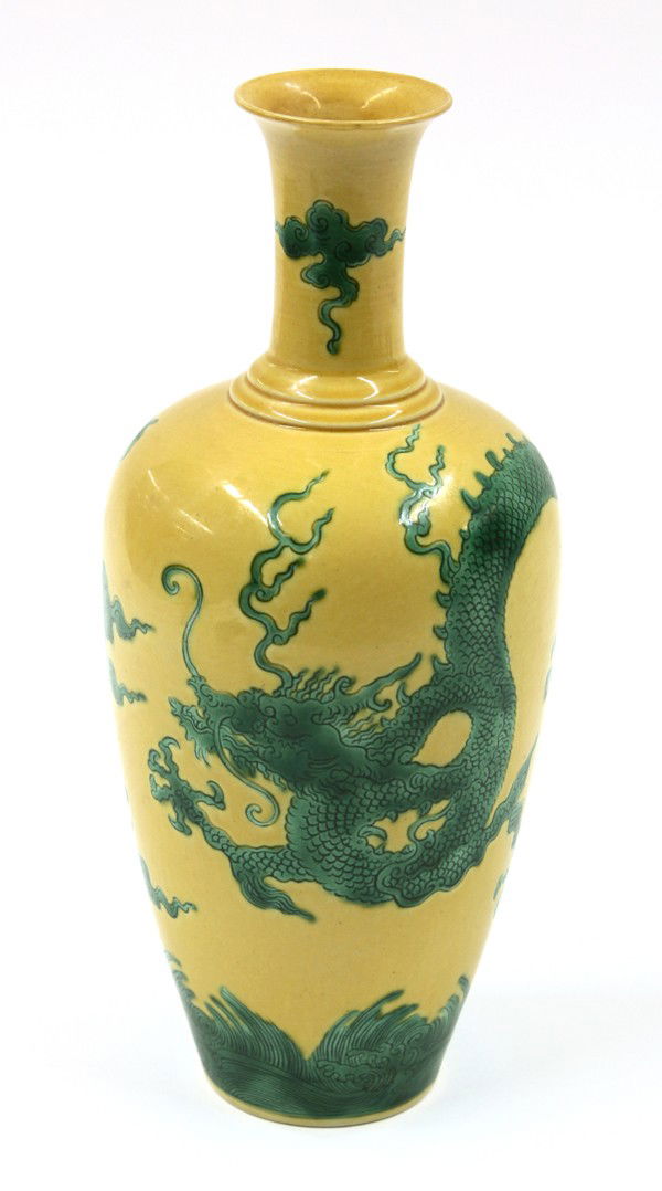 Chinese 'Egg and Spinach' Enameled Porcelain Vase: Chinese yellow and green enameled porcelain vase, the ovoid body incised with a sinous dragon flying through clouds above cresting waves, further cloud scrolls on the tall waisted neck encircled by a
