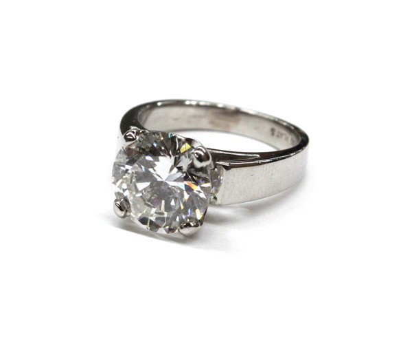 Diamond solitaire ring: Diamond solitaire ring; mounted in platinum, set with (1) diamond weighing 3.25 cts, total ring weight 7.9 grams, ring size 4