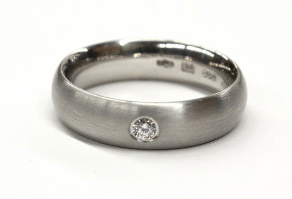 Gentleman's diamond platinum wedding band: Gentleman's diamond wedding band ring; of platinum, NEISSING designed, set with (1) round full cut diamond weighing 0.12 ct. Total weight 16.2 grams. Ring size 10.5. There is no buyer's premium on thi