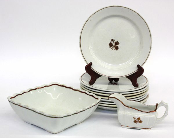 English Ironstone: (lot of 11) English ironstone tea leaf partial table service including nine dinner plates, one vegetable, and sauce