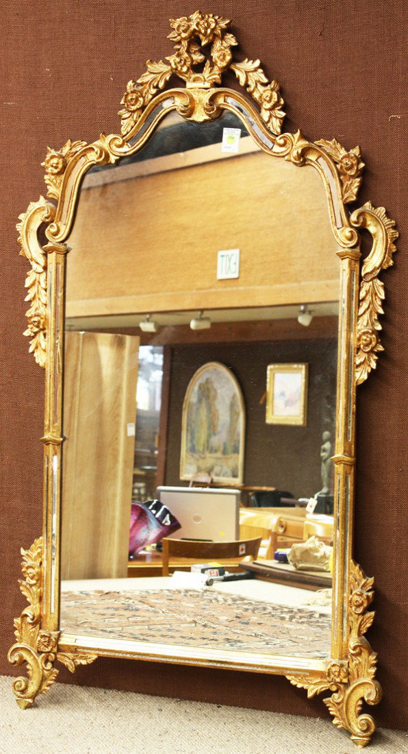 French trumeau mirror: French Neoclassical style partial gilt trumeau mirror, having an acanthus decorated crestrail surmounting the central medallion with bow and swag ornament, flanked with columnar pilasters centering th