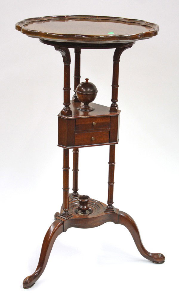 George III style walnut stand: George III style walnut wash basin stand, having a scalloped dish top above turned supports conjoined with a triangular two drawer case surmounted with a globular lidded compartment, rising on a tripo