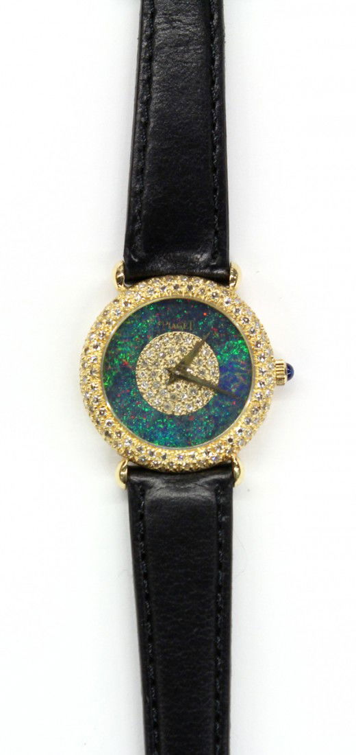 Piaget yellow gold diamond wristwatch: Lady's PIAGET wristwatch; of 18k yellow gold, having a circular opal framed, single cut diamond centered dial face and diamond set bezeled case. Serial/ref. # 90405 318789. Having an after market blac