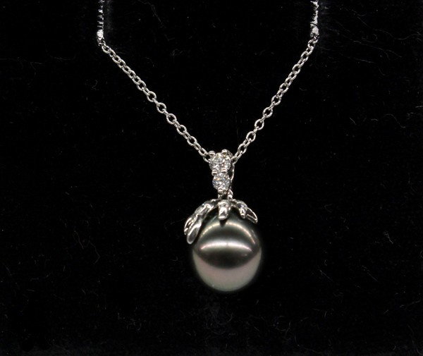 Pearl and diamond Tiffany and Co pendant: TIFFANY & CO. black pearl and diamond pendant with neckchain: mounted in platinum, set with (1) 8 mm black Tahitian cultured pearl and (22) diamonds weighing 0.15 ct. Total pendant and neckchain weigh